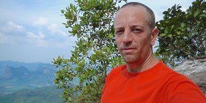 Author Vern Lovic at mountain top in Krabi, Thailand.