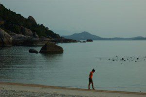 Girl walking at sunrise in meditation on the island of Koh Samui in Thailand's south.